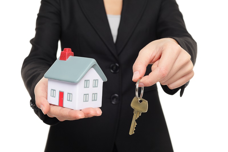 Real estate agent new house keys concept. Realtor showing holdin